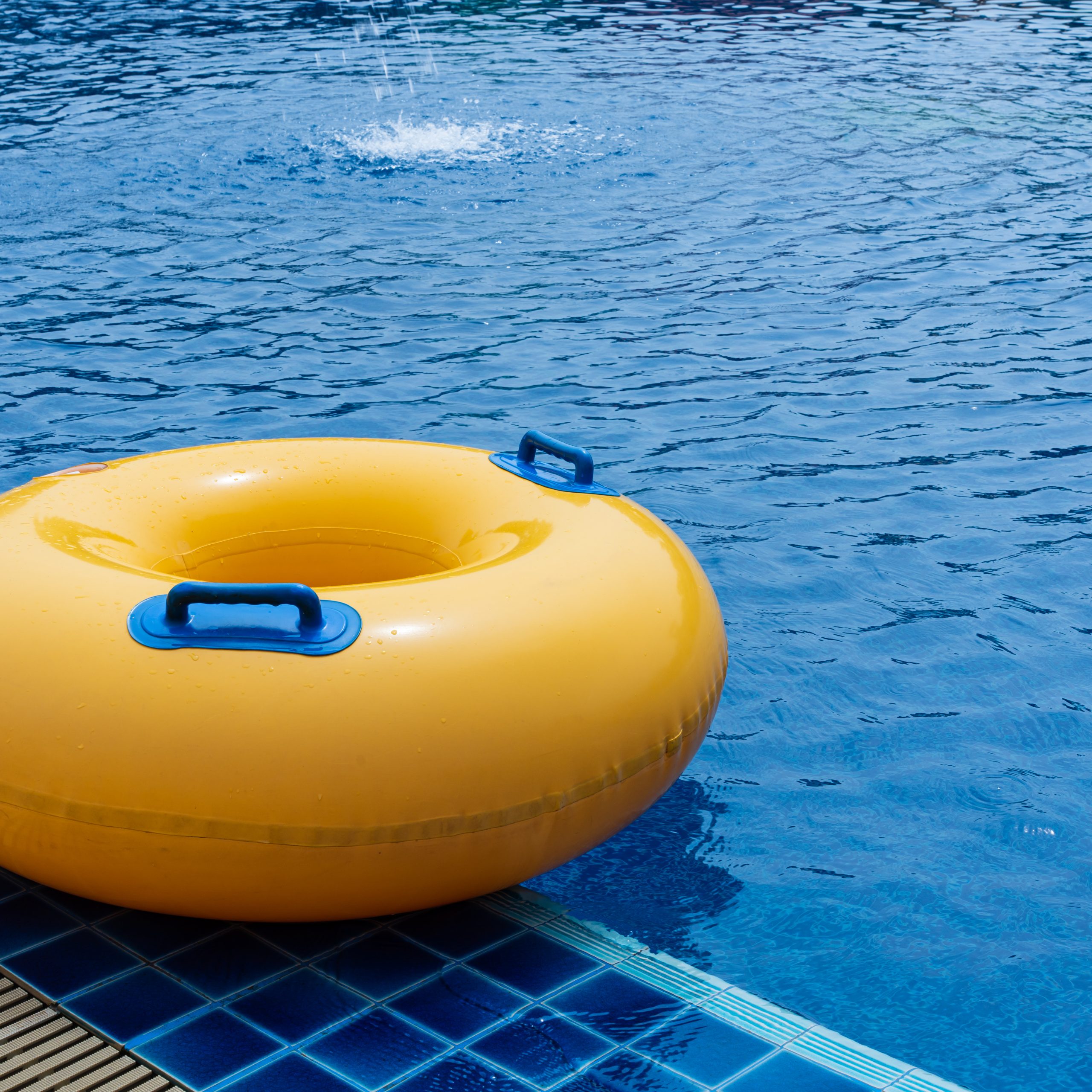 Yellow floating ring in swimming pool. Rubber ring swimming. Summer concept.