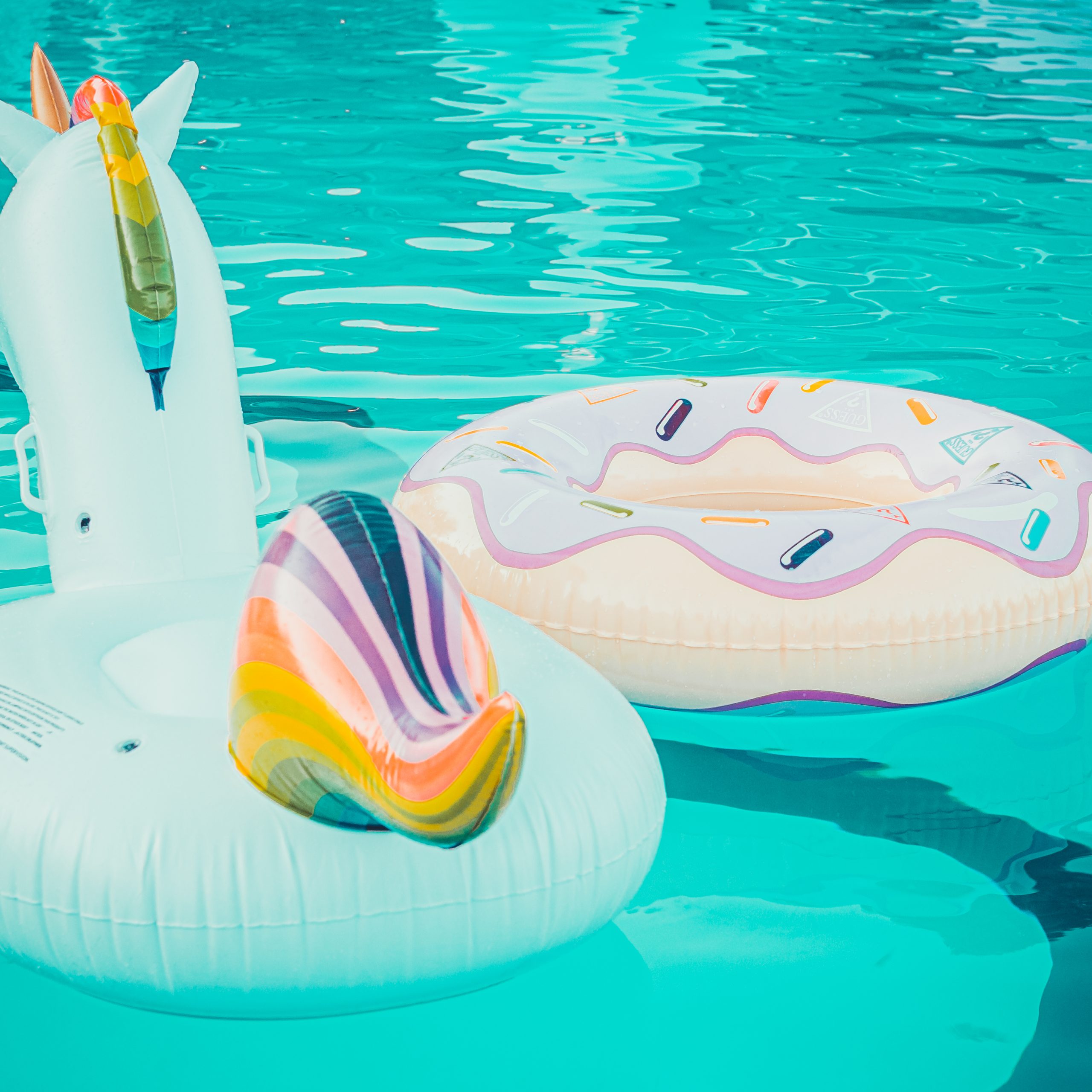 Yellow pool float, pool ring in cool blue refreshing blue pool
